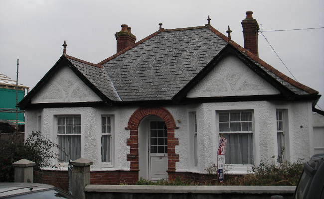 White house with dark grey skies above